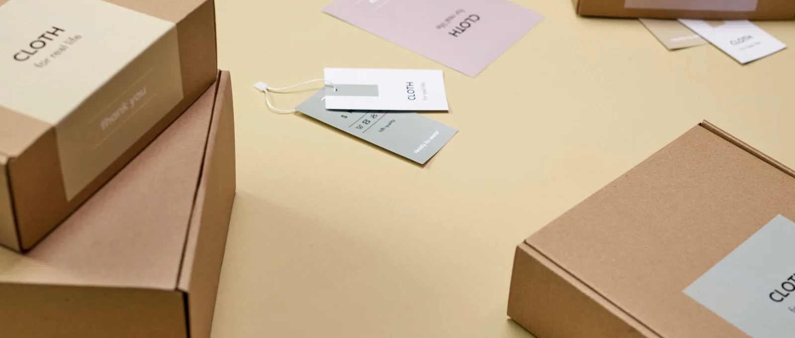 Cardboard product packaging arranged on a yellow surface